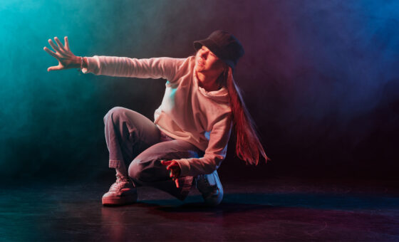 a girl in light clothes dances on a neon background in smoke, modern dance Θεατρικό Εργαστήρι Ενηλίκων